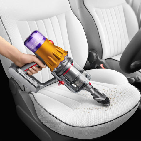 V12 Detect Slim Absolute Cordless Vacuum Cleaner With High Suction Power Ultra Lightweight Design removing debris from car seat