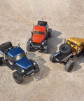 Three 1/10 Atlas RC Crawler 4WD with LED Lighting displayed in blue, orange, and yellow on rough outdoor terrain.