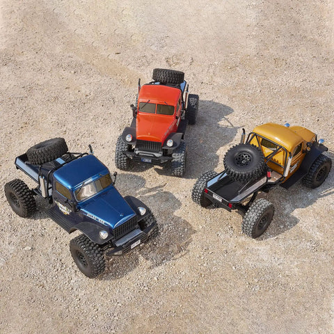 Three 1/10 Atlas RC Crawler 4WD with LED Lighting displayed in blue, orange, and yellow on rough outdoor terrain.