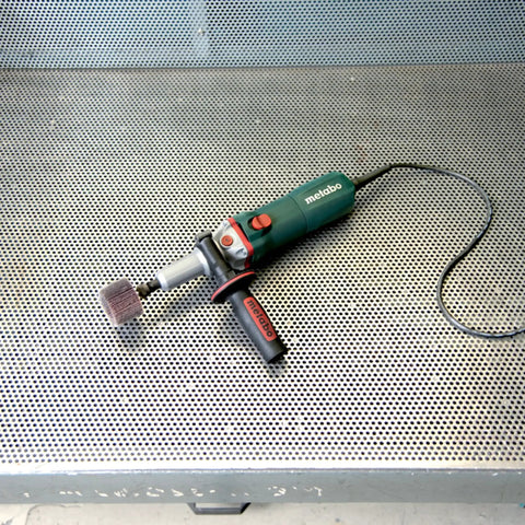 Heavy Duty Variable Speed Die Grinder With Badass High Torque Planetary Gears And Easy Swap Spindle Lock on metal surface