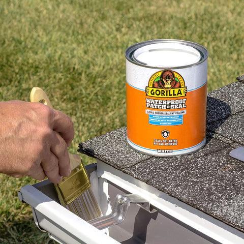 Person applying Patch And Seal Liquid Rubber Waterproof Sealant White 32 Ounce Easy To Apply By Brush Roll Trowel Dip Or Pour on gutter.