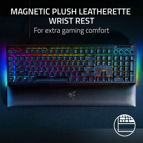 Top Tier Mechanical Gaming Keyboard With Kickass Clicky Green Switches And Lightning Fast Actuation Paired With Sleek Per Key RGB Underglow Lighting, featuring a magnetic plush leatherette wrist rest for comfort.
