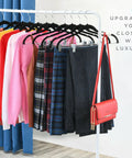 Ultra Thin Velvet No Slip Pants Hangers With Clips 10 Pack holding various clothes on a rack