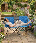Foldable Double Camping Chair With Storage For Two People Cozy Loveseat Style in a garden setting