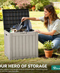 Woman organizing garden tools in an open 31 Gallon Outdoor Storage Deck Box With Lockable Lid, Waterproof Resin Construction, Taupe.