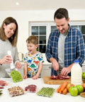 Family using Compact Food Vacuum Sealer With 60kPa Power, Rechargeable Handheld Kitchen Saver as sealing grapes in reusable bag.