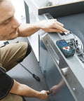 Person using GLM 50 C Laser Distance Meter 165 Ft With Backlit Display for kitchen layout measurement on counter