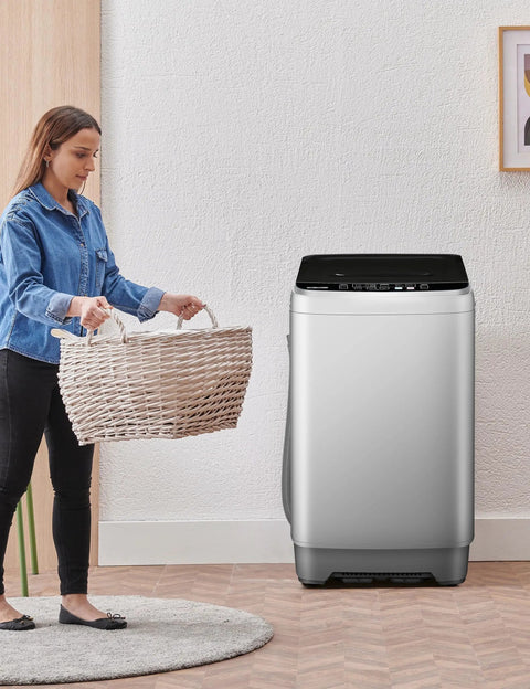 Lowkey Quiet Portable Washing Machine Full Automatic 2.0 Cubic Foot Compact Washer Grey next to woman carrying laundry basket.