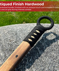 Cotton wrapped grip of Beefy 53 Inch Chinese Podao Halberd Polearm With Hand Forged High Carbon Steel Blade on stone surface.