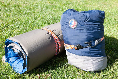 All Weather Must Have Adjustable Flat Bungee Cord securing camping gear on grass