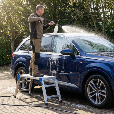 Person washing car using Height Adjustable Work Platform And Folding Aluminum Step Ladder Portable And Lightweight Yet Built Tough With 330 Lb Rating Perfect For Vehicle Washes Window Cleaning Do It Yourself Projects And Maintenance