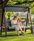 Woman and child reading on Three To Four Seat Porch Swing With Stand For Backyard Lounging, 990 Lbs Heavy Duty Outdoor Swing For Adults
