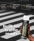 Traffic Marking Spray Paint 18oz 12-Pack White Quick-Dry Formula For Roads Parking Lots Sidewalks And Factory Floors can in hand