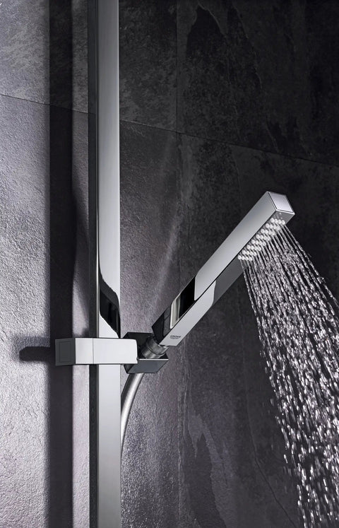 Euphoria Cube Plus 24 Inch Shower Bar in Starlight Chrome with water flowing from adjustable hand shower on dark tiled wall