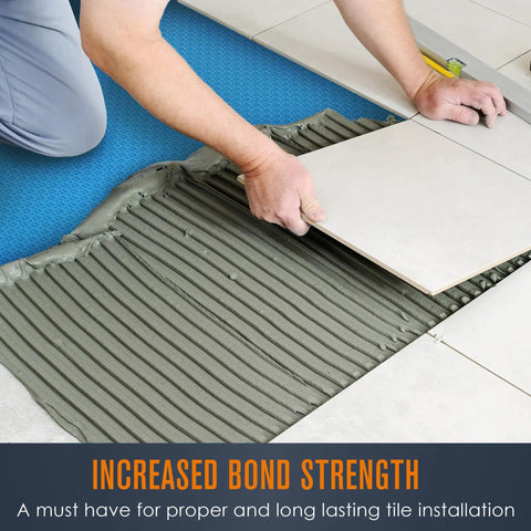 Person installing tile over Solid Uncoupling Membrane Roll For Tile Underlayment Spanning 150 Square Feet to ensure stability.