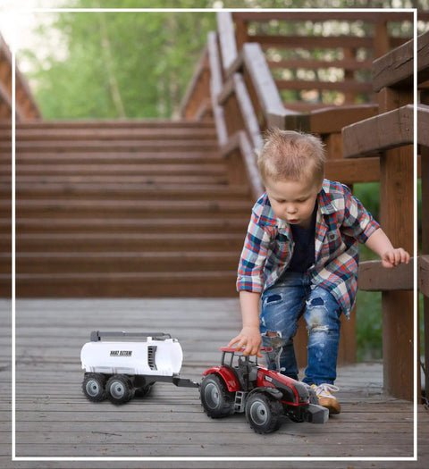 Child playing with Friction Powered Farm Tractor Trailer Toy Set 16 Inch Three Pack For Kids with red water tank trailer outdoors.