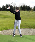 Golfer using Swing Plate Training Bundle With Extension Pole For Golf Swing Plane Practice Indoor Outdoor Trainer Aid on grass