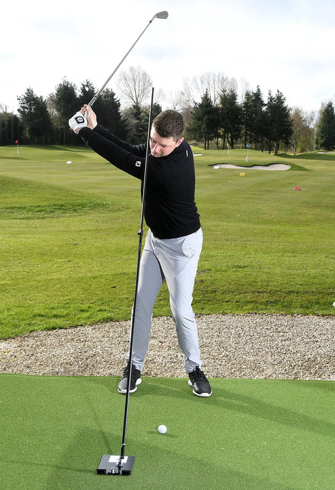 Golfer using Swing Plate Training Bundle With Extension Pole For Golf Swing Plane Practice Indoor Outdoor Trainer Aid on grass