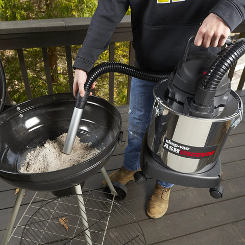 Person using Heavy Duty Beast 5 Gallon Ash Dry Vacuum With Stainless Steel Tank, 4 Peak HP for cleaning grill ashes