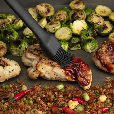 Grilled chicken and vegetables with basting brush on top, part of the 24 Piece Griddle Tool Set With Storage Tote Stainless Steel Flat Top Grill Accessories Spatulas Smash Burger Press Melting Dome Tongs Scraper Egg Rings Bottle Sprayers Salt And Pepper Shakers Cookout Ready For BBQ Tailgates And Camping.