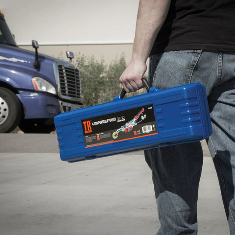 Person carrying Portable 4 Ton Dual Gear Power Puller All In One Lightweight Beast Under 10 Lbs with carry case