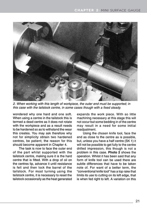 Metal lathe close-up in black-and-white showing tailstock, chuck, and cylindrical workpiece.