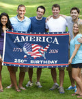 Group holding Totally All American 250th Anniversary Flag 3x5 Ft Double Sided Three Layer Fabric We The People 1776 2026