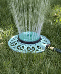 Sprout Metal 8 Pattern Sprinkler With Quick Connect Adapter Amazon Bundle In Gooseberry Green on grassy lawn in use