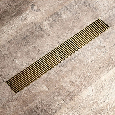 Top Tier Linear Shower Drain With Removable Grate and Built In Hair Catcher Crafted from Brushed Gold Stainless Steel, rectangular design