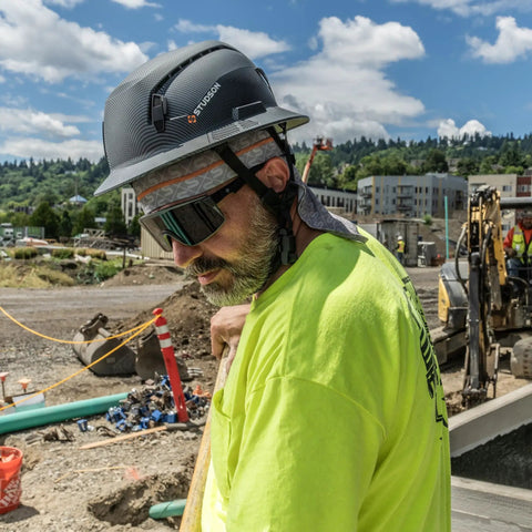 Premium Safety Glasses With Ansi Z87 Plus Impact Rating Featuring Anti Fog Vented Polycarbonate Lenses and a lightweight non slip grey frame on a worker.