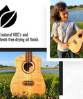 Woman holding guitar in field, showcasing all-natural VOC and solvent-free drying oil finish for wooden instruments.