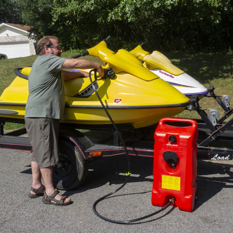 User refueling a yellow jet ski with Duramax Flo N Go 14 Gallon Gas Caddy On Wheels With 10 Foot Hose And Portable Fuel Tank Transfer Pump