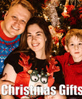 Family portrait celebrating Christmas with gifts, dressed in festive attire and surrounded by holiday decorations.