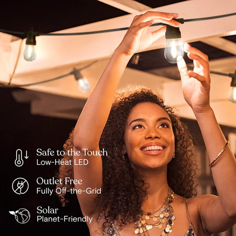 Woman installing Solar Powered Outdoor String Lights 27 Ft With 12 Shatterproof LED Edison Bulbs Waterproof Patio Lights.