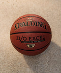 Zi O Excel Indoor Outdoor Basketball 29.5 Inch Official Size 7 with foam backed feel on a concrete surface.