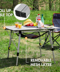 Foldable Outdoor Picnic Camping Table With Adjustable Height Aluminum Legs And Roll Up Top in a backyard setup.