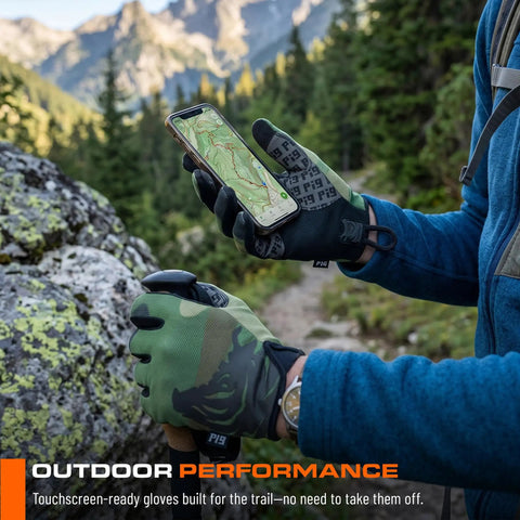 Hiker wearing FDT Delta Utility Gloves With Touchscreen Compatibility in Coyote Brown Large, using smartphone on mountain trail.