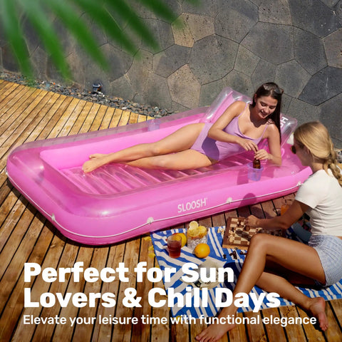 Two women relaxing with drinks on Inflatable Tanning Pool Lounger With Pillow 70 By 46 Inches Personal Water Filled Float in pink