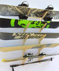Premium Wall Rack Mount For Ski Snowboard And Longboard Storage Featuring Adjustable Baltic Birch Arms Heavy Duty Gear Holder Holds Up To One Hundred Twenty Pounds with skis and snowboards displayed.