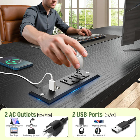 Person using power outlets on 39.3 Inch Gaming Desk with LED lights, dual monitor stand, black, ideal for small spaces.