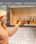 Built Tough 3 Tier Expandable Spice Rack Featuring Adjustable Length And Secure Non Slip Shelves Ultimate Game Changer For Kitchen Cabinet Pantry Or Countertop 2 Pack White And Grey with jars visible in a cabinet.
