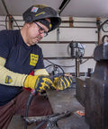 Man using a tool in a workshop wearing Heavy Duty Eighteen Inch Kevlar Arm Sleeves Featuring Legit A3 Cut Resistant Armor.
