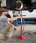 Short Underhoist Support Stand 1500 Lb Capacity Adjustable Height Range For Engine Swap And Suspension Work Fits Two Post Lifts Garage Wrenching Essential For Car Enthusiasts And Pro Mechanics in use by a mechanic.