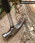 Hammer driving 3.5 inch copper spike into tree stump from 20 Pcs Pure Copper Nails For Killing Trees Kit.