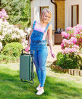 Woman in garden holding Garden Kneeler And Seat Folding Heavy Duty Bench With Removable Tool Bags For Weeding Pruning Planting And Outdoor Tasks
