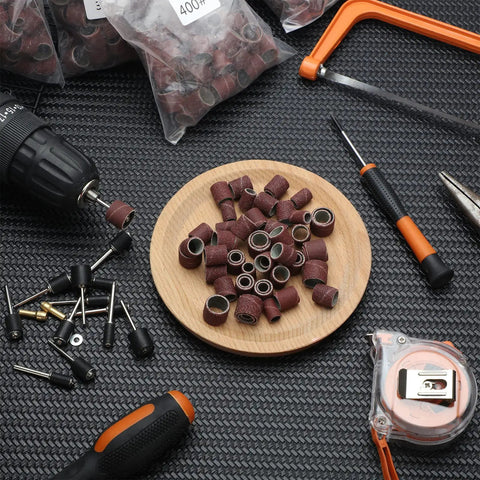 Pro Grade 890 Piece Sanding Drum Set with rods, drill chucks, and sanding grits on display for grinding and finishing projects.