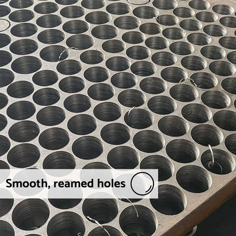 Annular cutter: top-down view of a metal sheet with uniform 5/8 in holes and smooth reamed edges