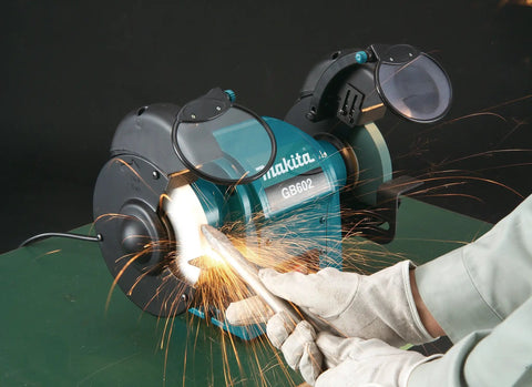 Heavy Duty 250 Watt Bench Grinder Featuring Dual Illuminated Work Lights And Rock Solid Base For smooth metal grinding and tool restoration in use.