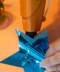 Using Clear Mini Hot Glue Sticks 4 Inch Long 0.27 Inch Diameter 75 Count For All Temperature Glue Guns on blue foil star