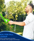 Man using Quick Change Blade Cordless Garden Shears For Snipping Grass And Trimming Hedges in a lush garden.